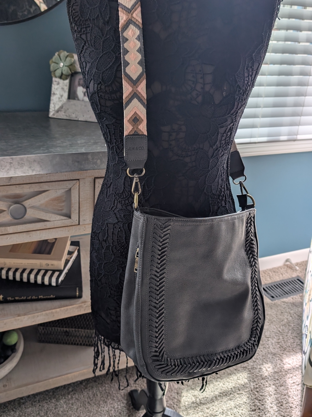 Black Crossbody Shoulder Bag with Woven Trim and Patterned Strap
